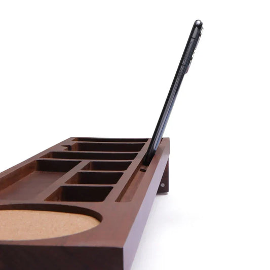 Brown desk organizer with compartments and a pen on a white background