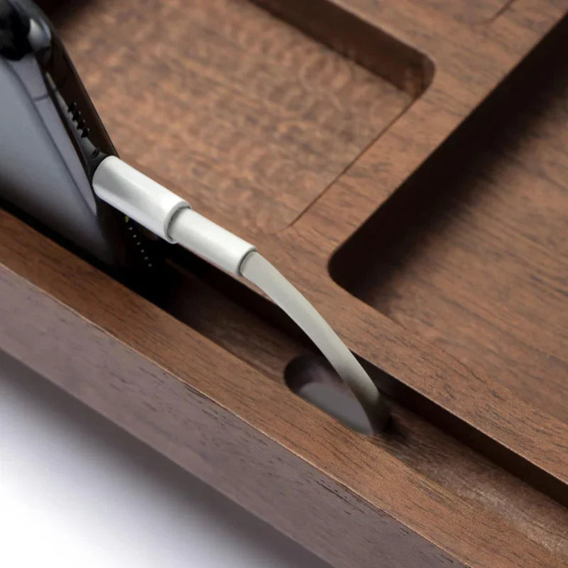 Wooden desk with a cable plugged into a device