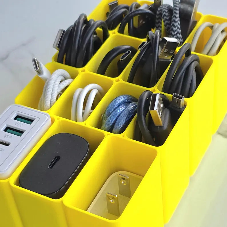 Yellow cable organizer with various charging cables and a power adapter.
