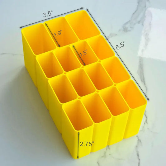 Yellow plastic organizer with measurements on a marble surface